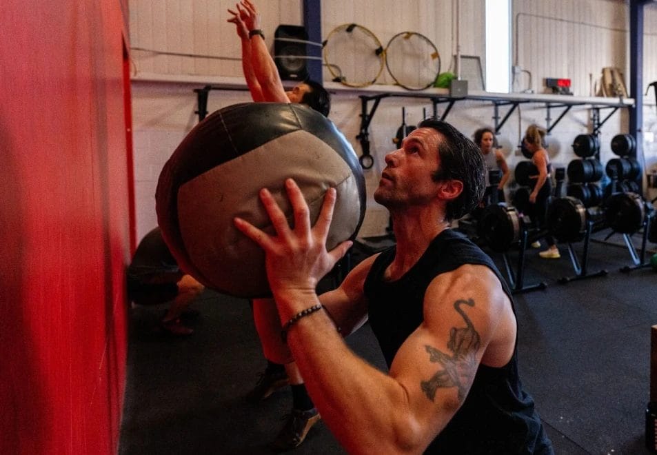 Man doing wall ball exercise